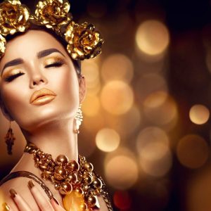 پوستر چهره زه با آرایش و زیورآلات طلایی روی زمینه مشکی طلایی