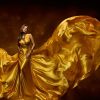 پوستر زن زیبا با لباس طلایی بلند پیچیده در باد و زمینه قهوه ای